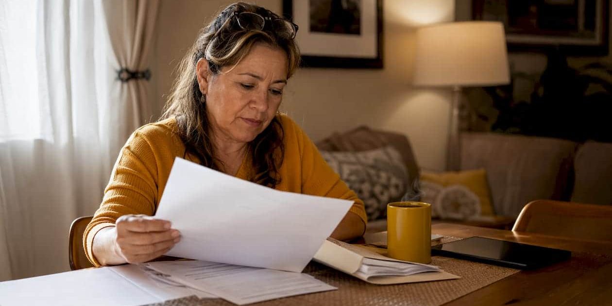 1784735135392_Woman-reviewing-Arizona-divorce-paperwork Woman reviewing Arizona divorce paperwork