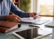 Hands organizing business documents and assets