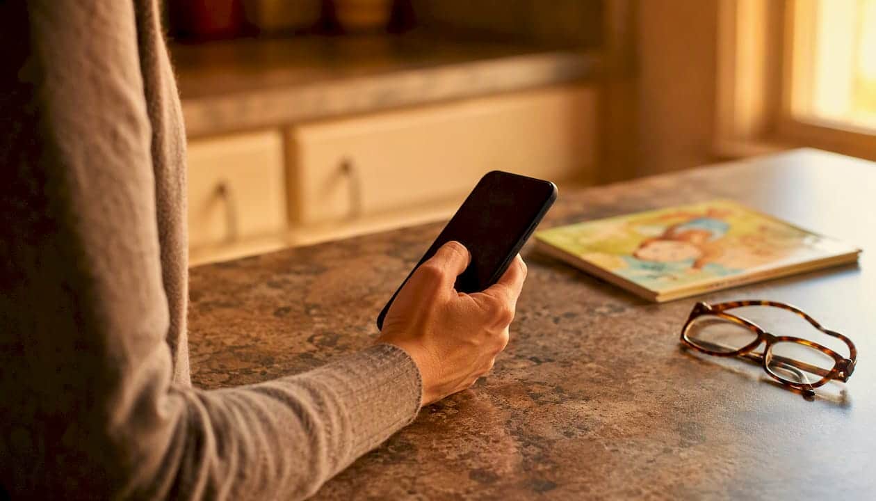 Parent preparing to send childcare notice by phone