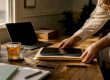 Hands organizing disclosure documents and devices