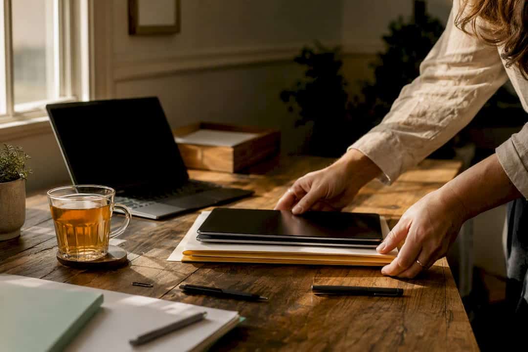 Hands organizing disclosure documents and devices