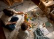 Parent’s hand moving toy car on table with calendar