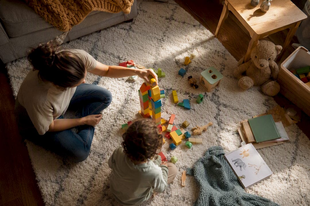 Parent’s hand moving toy car on table with calendar
