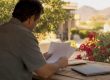 Hands organizing retirement papers on table