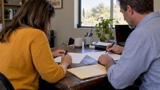 Couple reviewing a signed divorce agreement