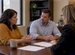 Couple negotiating settlement terms with mediator
