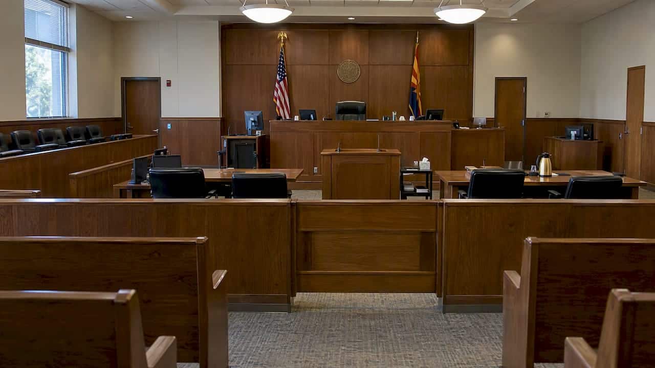 Empty courtroom with judge’s bench and counsel tables