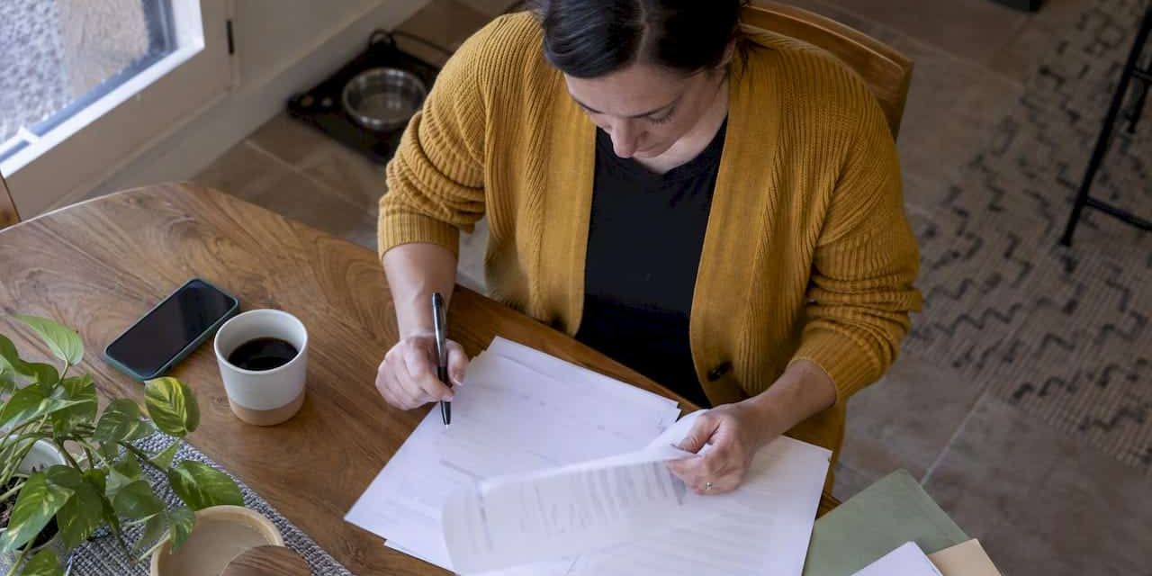 1791458158514_Parent-reviewing-a-child-support-worksheet Parent reviewing a child support worksheet