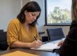 Homeowner signing mortgage refinance documents