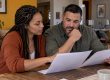 Couple reviewing a cohabitation agreement at home