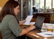 Woman comparing health insurance options at home