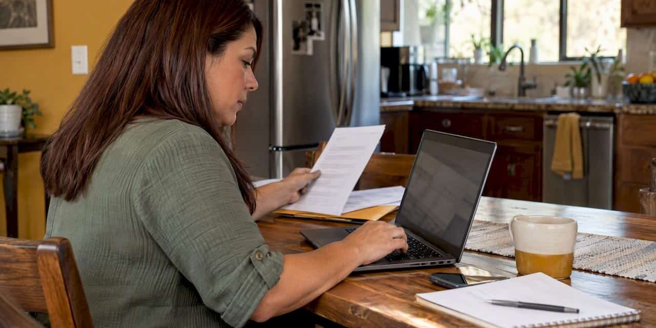 1792895811920_Woman-comparing-health-insurance-options-at-home Woman comparing health insurance options at home
