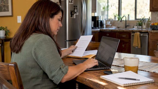 Woman comparing health insurance options at home